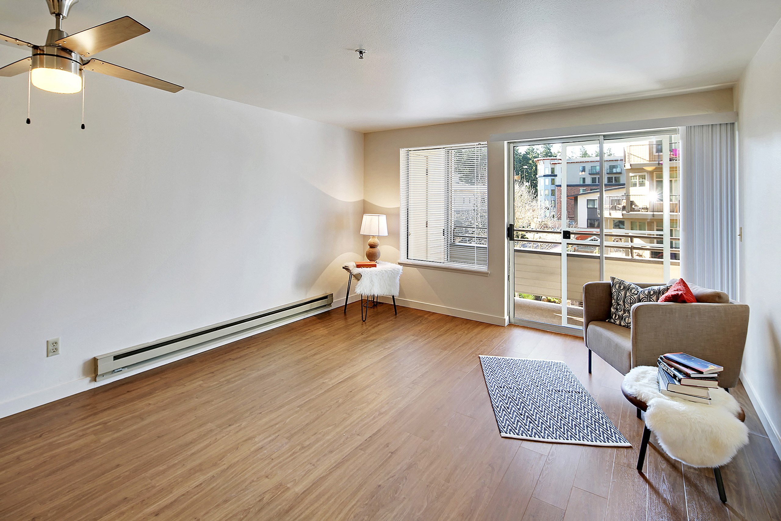 a living room with a couch and a chair and a window